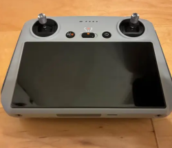 DJI RC controller. It has a screen protector on so there are no scratches on the screen. I used this for my Mini 3 before it crashed and of course my new one doesn’t work with this. No holds Image